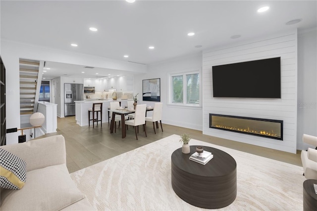 living room featuring a fireplace and light hardwood / wood-style flooring