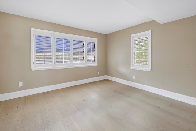 spare room with light hardwood / wood-style flooring