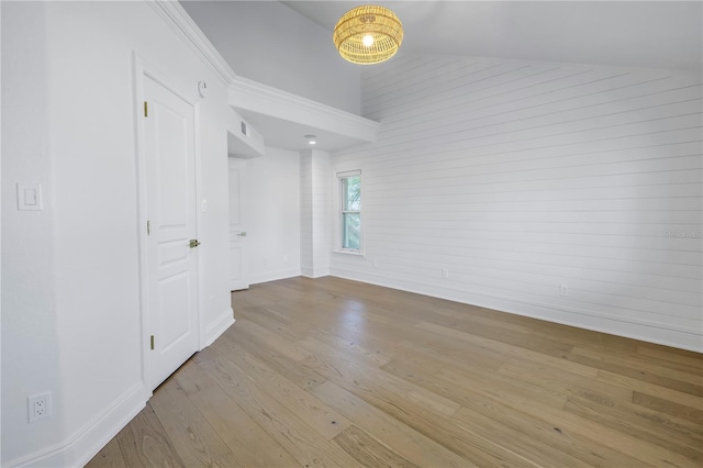 spare room with lofted ceiling and light hardwood / wood-style floors