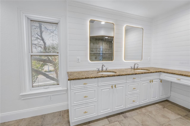 interior space with stone countertops, sink, and white cabinets