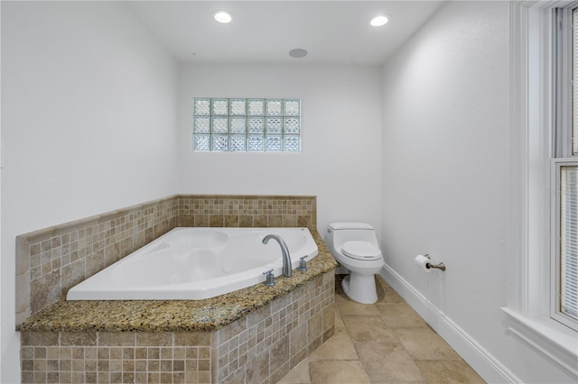 bathroom with a relaxing tiled tub and toilet