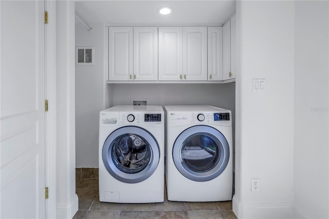 laundry area featuring cabinets and washing machine and clothes dryer