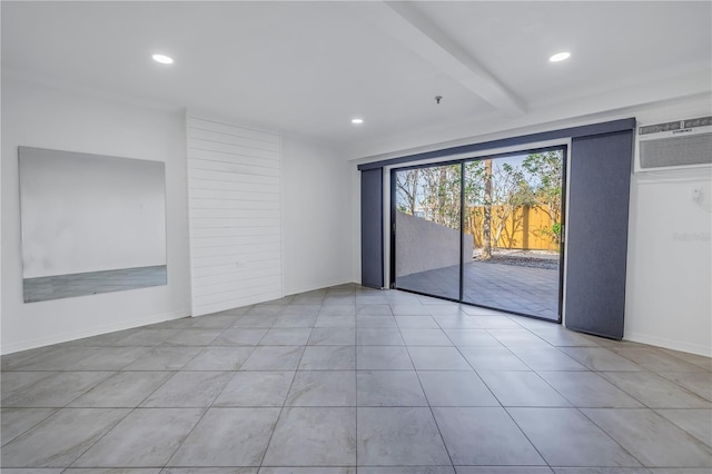 empty room with beamed ceiling, a wall mounted AC, and light tile patterned floors