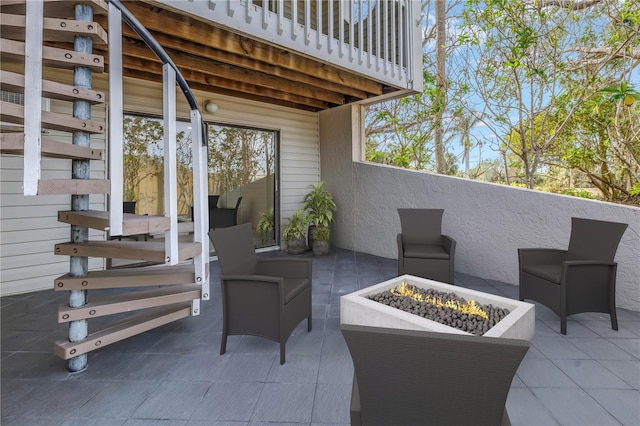 view of patio / terrace featuring a balcony and a fire pit