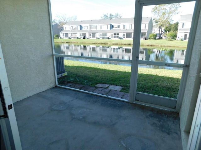 exterior space with a patio area, a water view, and a residential view