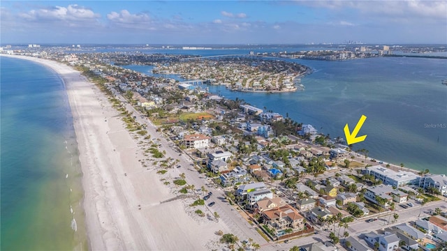 birds eye view of property with a water view and a view of the beach