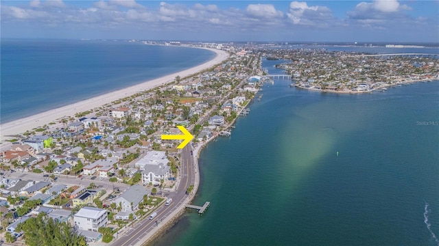 bird's eye view with a water view and a beach view