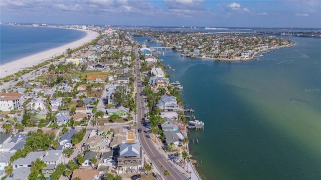 drone / aerial view with a water view and a beach view