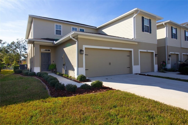 view of front of home with a front lawn, central AC unit, and a garage