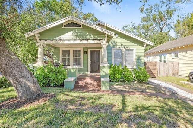 bungalow-style home featuring a porch and a front lawn