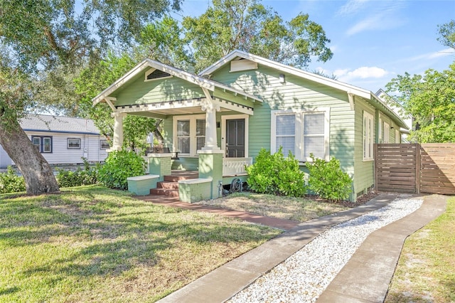 bungalow-style home featuring a front yard and a porch