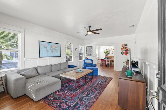 living room featuring hardwood / wood-style flooring and ceiling fan