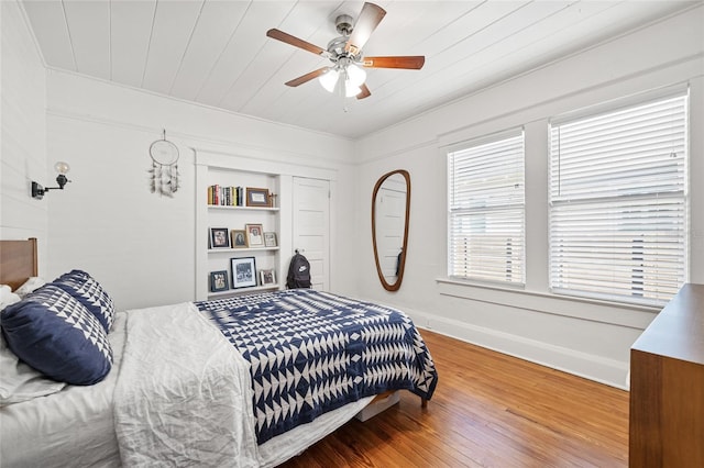 bedroom with ceiling fan, hardwood / wood-style floors, and wood ceiling