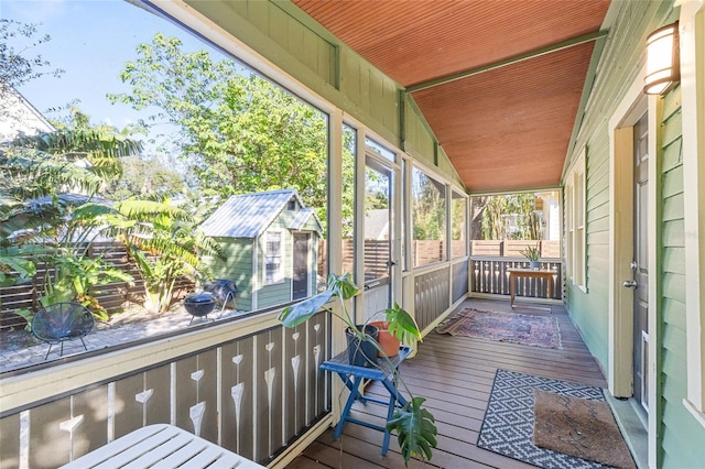 unfurnished sunroom with vaulted ceiling and wood ceiling