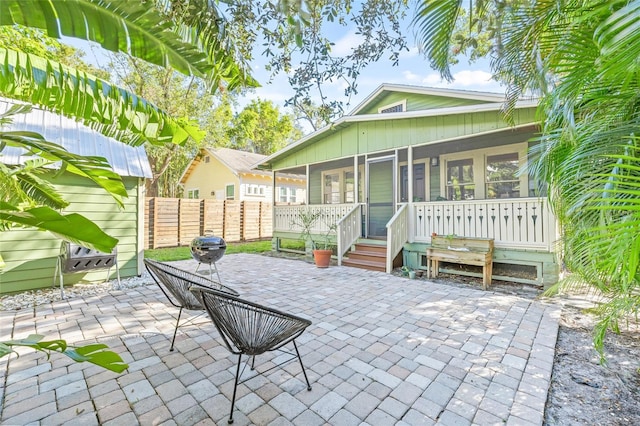 back of house with a sunroom and a patio