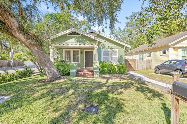 bungalow featuring a porch and a front yard