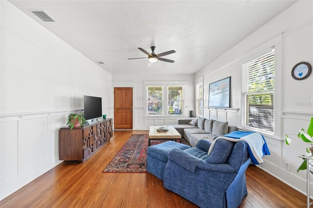 living room with hardwood / wood-style floors, plenty of natural light, and ceiling fan