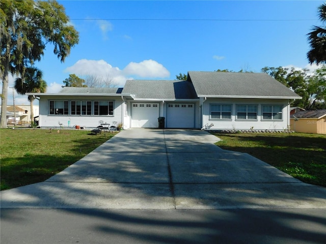 single story home featuring a garage and a front yard