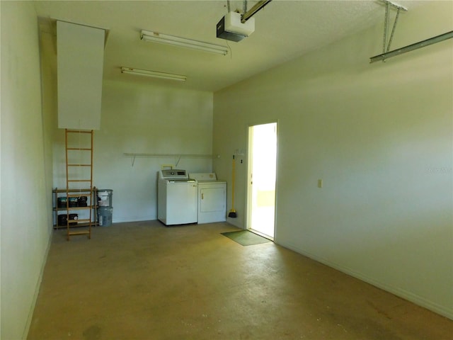 garage with washing machine and clothes dryer and a garage door opener