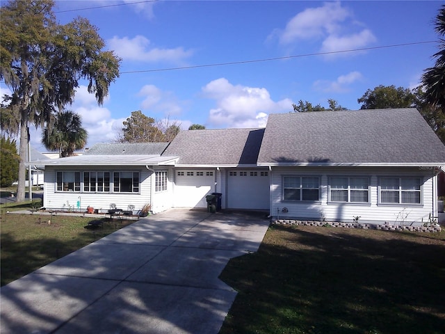 ranch-style house featuring a front lawn and a garage