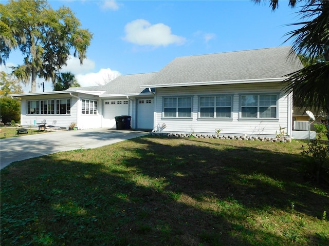 single story home featuring a front lawn and a garage