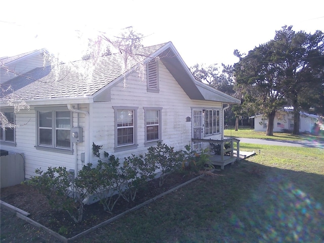 view of property exterior with a yard