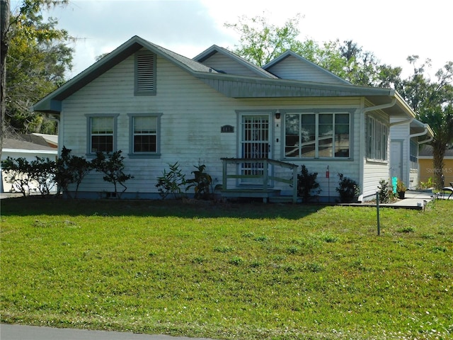 bungalow-style house featuring a front yard