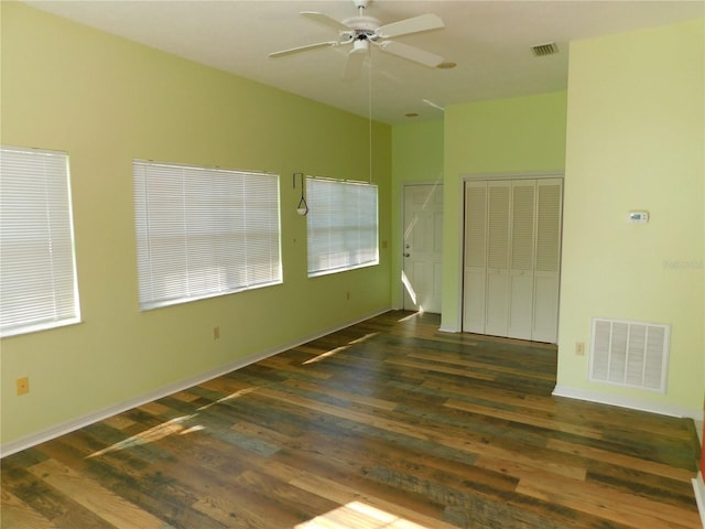 spare room with ceiling fan and dark hardwood / wood-style flooring