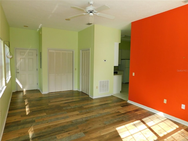 spare room with ceiling fan and hardwood / wood-style flooring