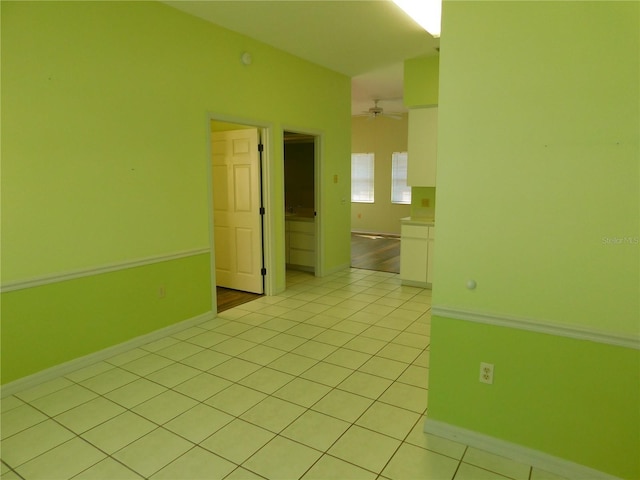 tiled empty room with ceiling fan