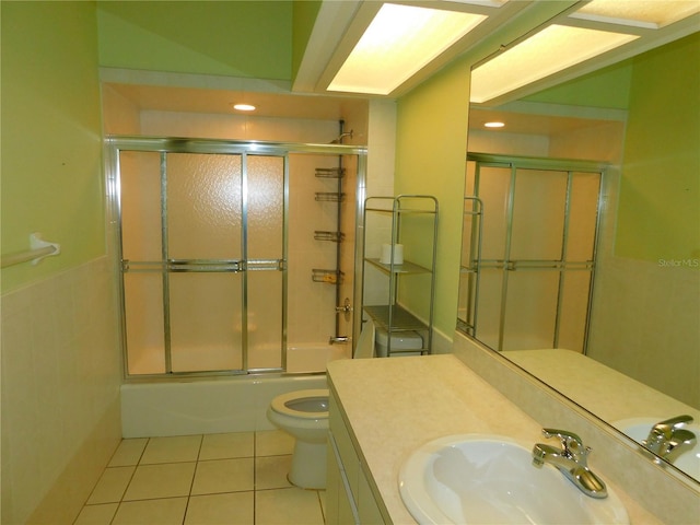 full bathroom with tile patterned flooring, vanity, toilet, and bath / shower combo with glass door