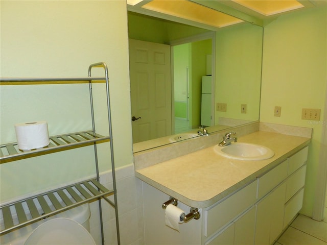 bathroom featuring tile patterned flooring and vanity