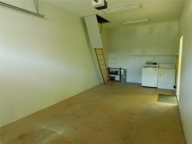 garage featuring separate washer and dryer and a garage door opener