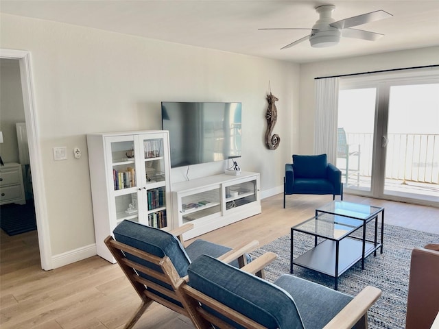 living room featuring light hardwood / wood-style floors and ceiling fan