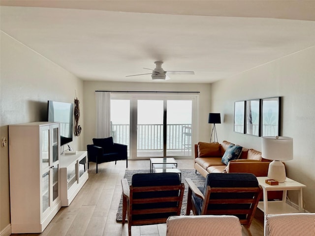 living room featuring ceiling fan and light hardwood / wood-style flooring