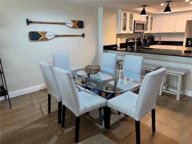 dining space with wood-type flooring