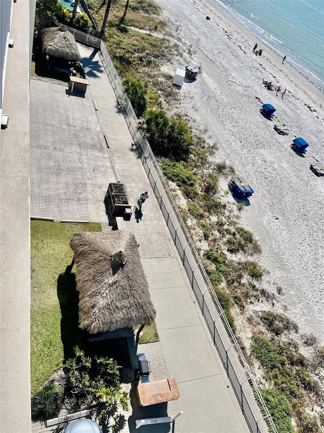 birds eye view of property featuring a water view and a beach view