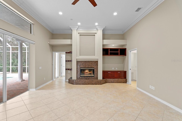 unfurnished living room featuring ceiling fan, a tile fireplace, crown molding, and light tile patterned flooring