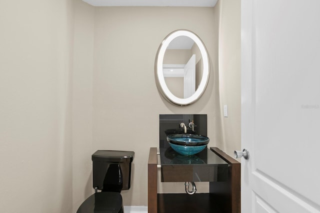 bathroom featuring toilet and sink