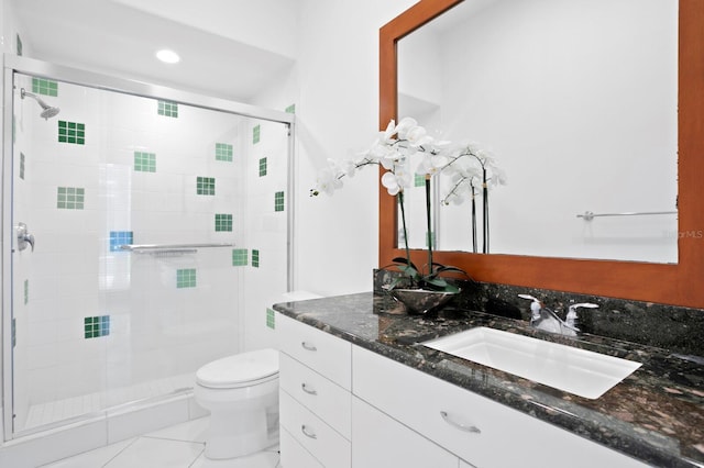 bathroom featuring toilet, an enclosed shower, and vanity