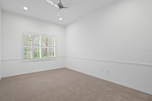 carpeted empty room featuring ceiling fan