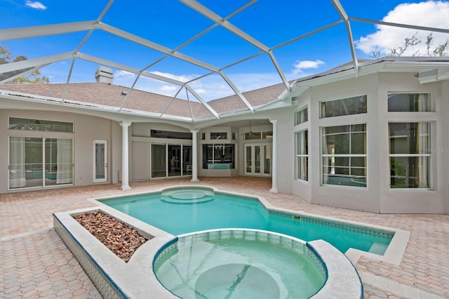 view of swimming pool featuring glass enclosure, an in ground hot tub, french doors, a patio, and ceiling fan