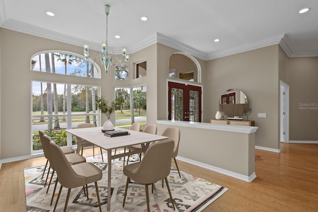 10106 Radcliffe Dr, Tampa, FL 33626 - dining area featuring recessed lighting, crown molding, a chandelier, baseboards, and light wood-type flooring