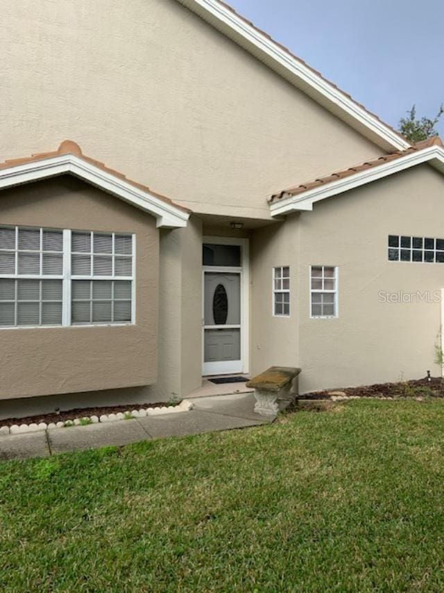 rear view of house featuring a yard