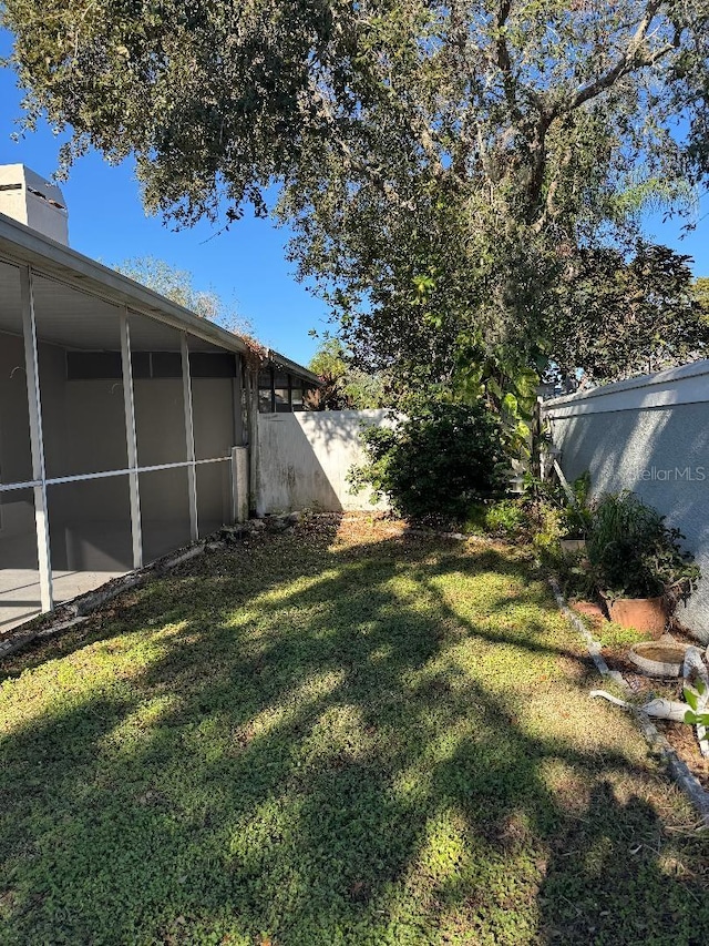 view of yard with a sunroom