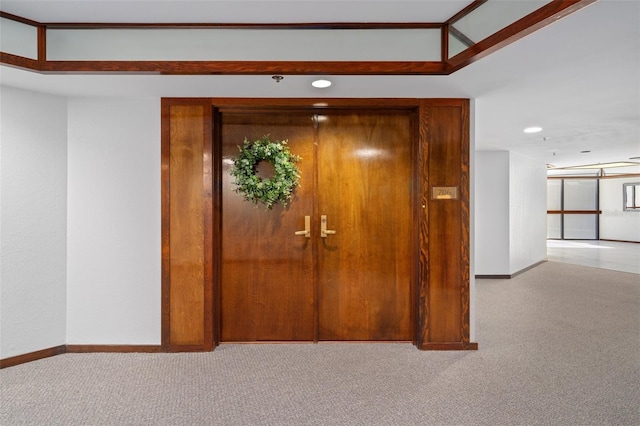 hall featuring light carpet