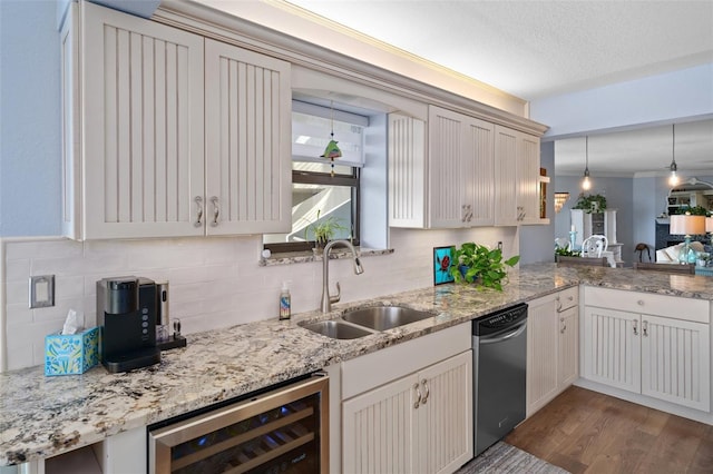 kitchen with sink, hanging light fixtures, tasteful backsplash, wine cooler, and stainless steel dishwasher