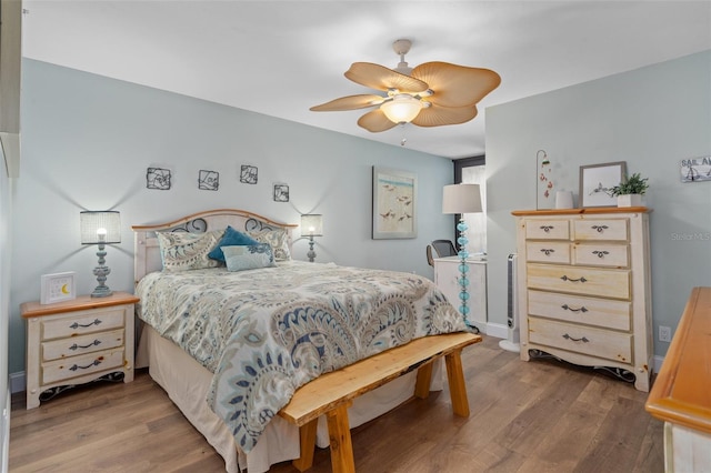 bedroom with hardwood / wood-style floors and ceiling fan