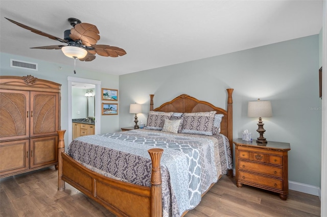 bedroom featuring dark hardwood / wood-style flooring, connected bathroom, and ceiling fan