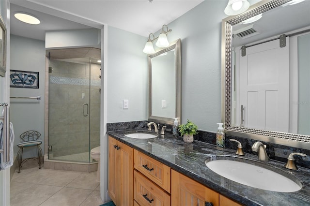 bathroom with tile patterned flooring, vanity, an enclosed shower, and toilet